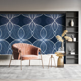 Geometric blue wallpaper adding depth to a modern bedroom wall