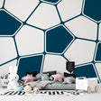 Modern geometric wallpaper in bright home office with white desk and natural light