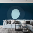 Modern geometric circle wallpaper in a bright living room, showing smooth lines and blue tones creating depth