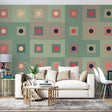 Geometric pattern wallpaper bringing modern style to a minimalist living room with sage and coral accents