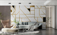 Modern geometric gold wallpaper in bright living room with grey sofa and plants