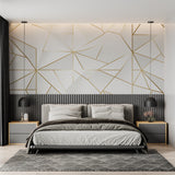 Hallway decorated with white and gold geometric wallpaper in natural lighting