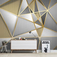 Modern geometric wallpaper with gold lines in a bright living room setting showing depth and luxury