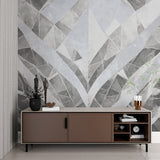 Grey geometric wallpaper mural creating depth in modern living room setting