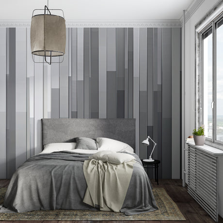Modern grey stripe wallpaper in a minimalist living room with natural light highlighting the gradient pattern