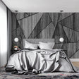 Modern geometric wood wallpaper in minimalist living room with grey sofa and natural lighting