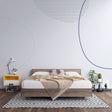 Modern geometric line art wallpaper in a bright, minimalist living room showing curved patterns and clean lines