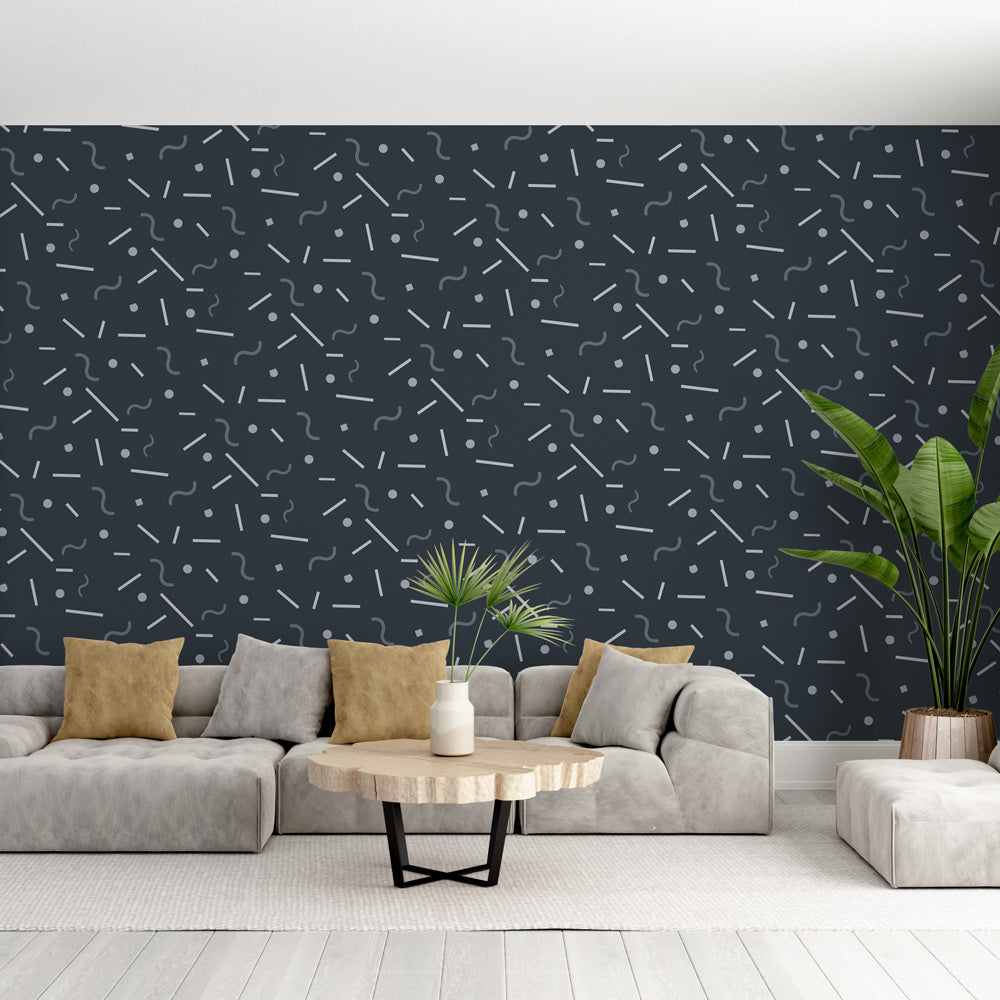Modern geometric wallpaper with lines and dots pattern shown in a minimalist living room setting with grey sofa
