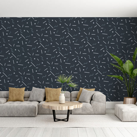 Modern geometric wallpaper with lines and dots pattern shown in a minimalist living room setting with grey sofa