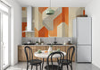 Modern geometric orange wallpaper in contemporary living room setting with minimal furniture
