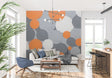 Modern geometric circle wallpaper in stylish living room with grey sofa and orange accents