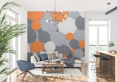 Modern geometric circle wallpaper in stylish living room with grey sofa and orange accents