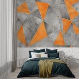 Geometric accent wall mural in modern dining room with orange and grey triangular design