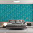 Modern geometric wallpaper in a bright home office space, showing coral and yellow pattern creating an energetic workspace atmosphere