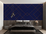 Geometric navy and gold wallpaper creating drama in master bedroom with pendant lights