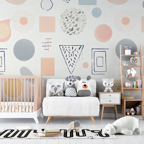 Geometric nursery wallpaper with pastel shapes brightening a modern baby room with white furniture