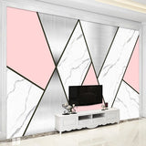 Modern geometric wallpaper with pink and marble design styled in a bright contemporary living room setting