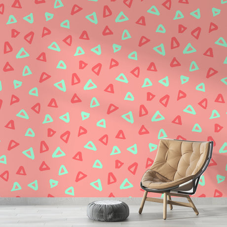 Pink geometric triangle wallpaper with mint accents shown in a bright modern home office with minimalist furniture