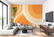 Geometric orange circle wallpaper brightening a modern living room with mid-century furniture