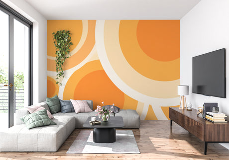 Geometric orange circle wallpaper brightening a modern living room with mid-century furniture