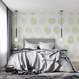 Scandinavian dining room with geometric green circle wallpaper adding subtle visual interest