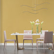 Gold wallpaper mural showcased in a modern living room with tall windows and contemporary furniture
