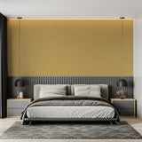 Plain gold wallpaper creating a warm ambiance in a master bedroom