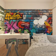 Street art graffiti wallpaper creating bold impact in modern living room with grey sofa