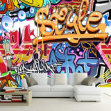 Graffiti wallpaper bringing urban style to a modern living room with bold orange and blue street art design