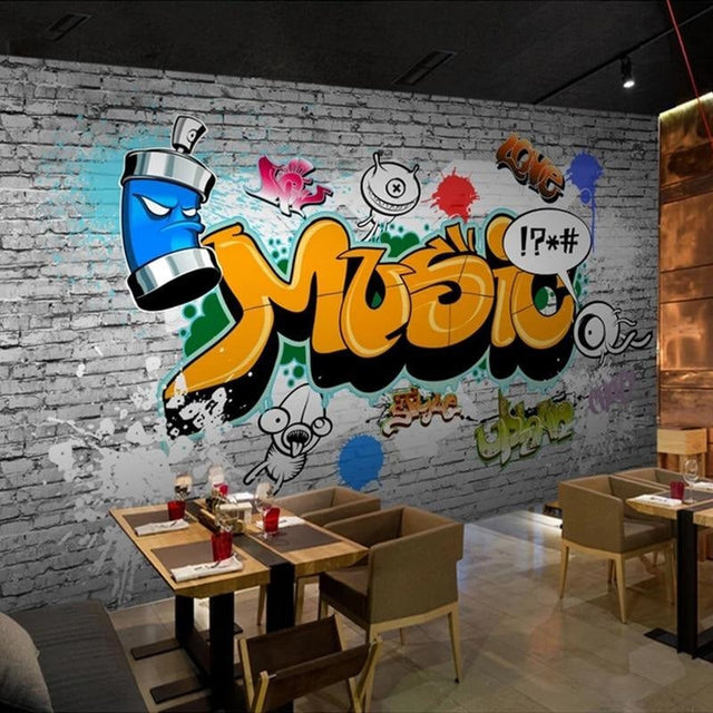Graffiti wallpaper mural creating bold impact in modern teen bedroom with gaming setup and LED lights