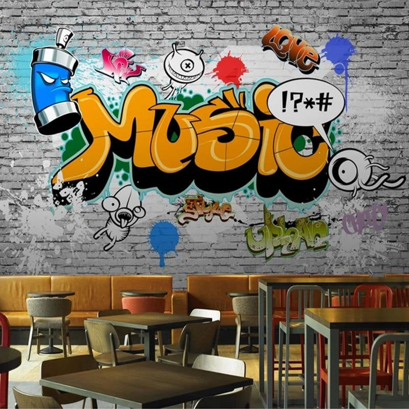 Urban street art wallpaper making statement in creative office space with industrial furniture