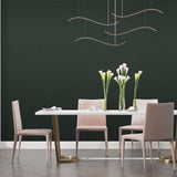Deep forest green wallpaper creating a cozy atmosphere in modern living room with natural light