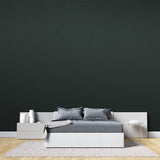 Elegant dining room featuring solid green wall mural with pendant lighting
