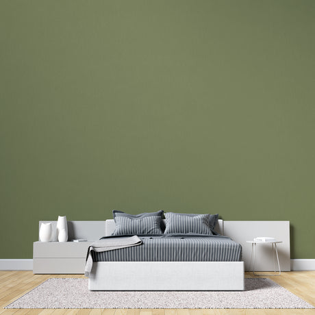 Modern green wall mural in bright living room showing peaceful khaki tones