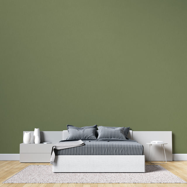 Modern green wall mural in bright living room showing peaceful khaki tones