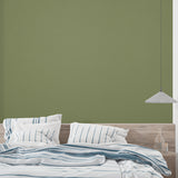 Modern olive green wallpaper in bright living room with minimalist furniture