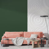 Green wall covering in a dining room with contemporary furniture and pendant lights