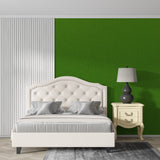 Minimalist bedroom featuring deep green wall mural