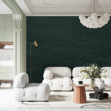 Deep green wall covering showcased in master bedroom with gold accents