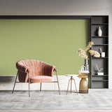 Natural green wallpaper adding depth to a dining room with wooden furniture