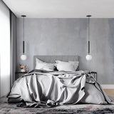 Grey concrete wallpaper adding industrial charm to dining room walls