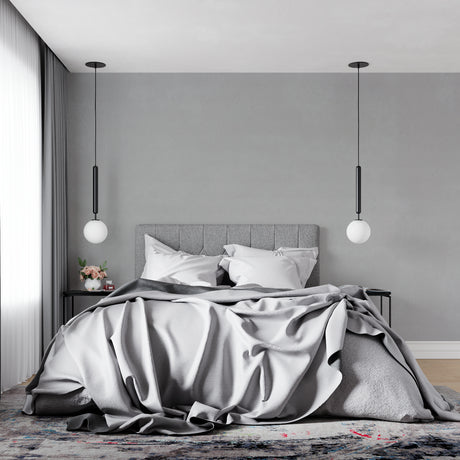 Modern grey wallpaper mural in a minimalist living room with natural light highlighting its subtle texture
