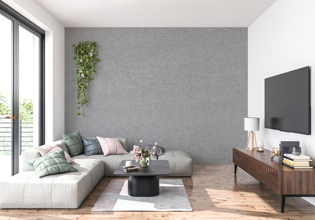 Modern grey textured wallpaper in a bright living room setting with minimal furniture