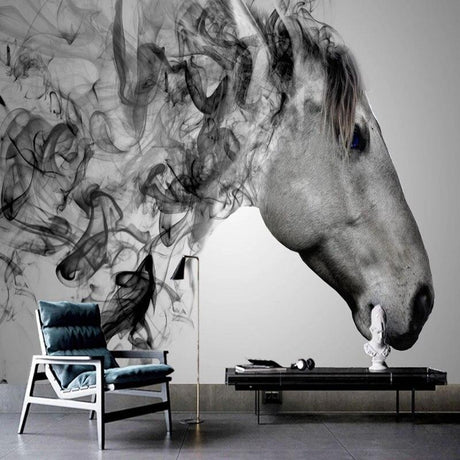 Black and white horse wallpaper creating drama in a modern living room with grey sofa and minimal decor
