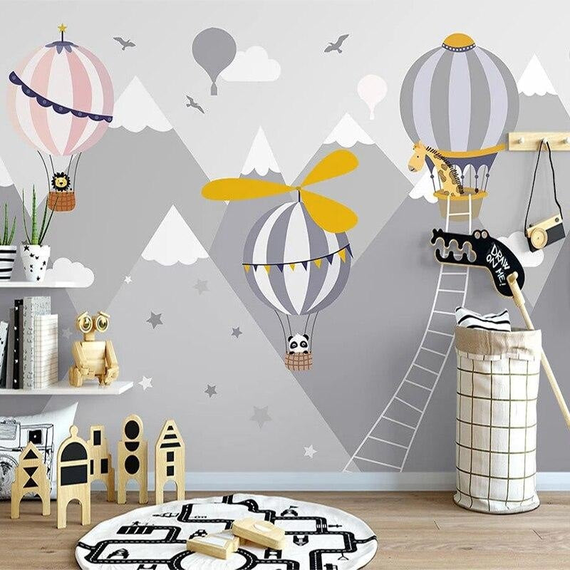 Mountain adventure wallpaper with hot air balloons bringing magic to a cozy playroom setting