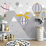 Mountain adventure wallpaper with hot air balloons bringing magic to a cozy playroom setting