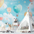 Hot air balloon wallpaper creating a magical atmosphere in a bright nursery with white furniture