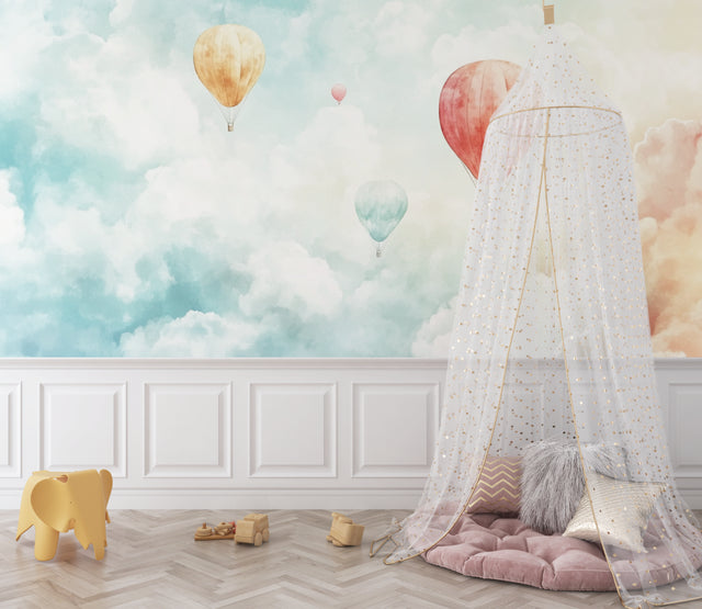 Hot air balloon wallpaper creating a dreamy atmosphere in a bright nursery with white furniture