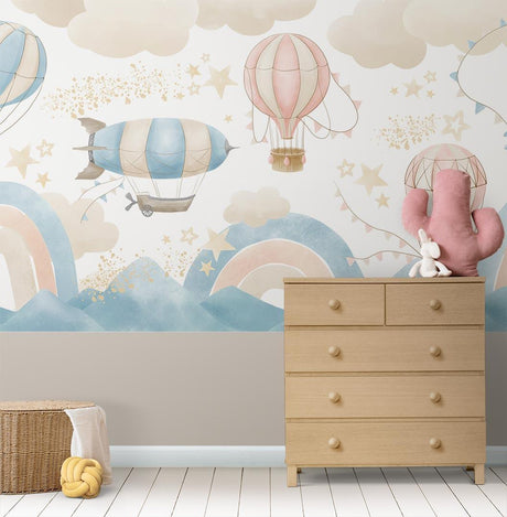 Hot air balloon wallpaper mural in a bright nursery, showing pink and blue balloons floating above a child's crib
