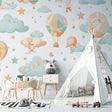 Hot air balloon nursery wallpaper in a cozy nursery setting with soft lighting and gentle colors